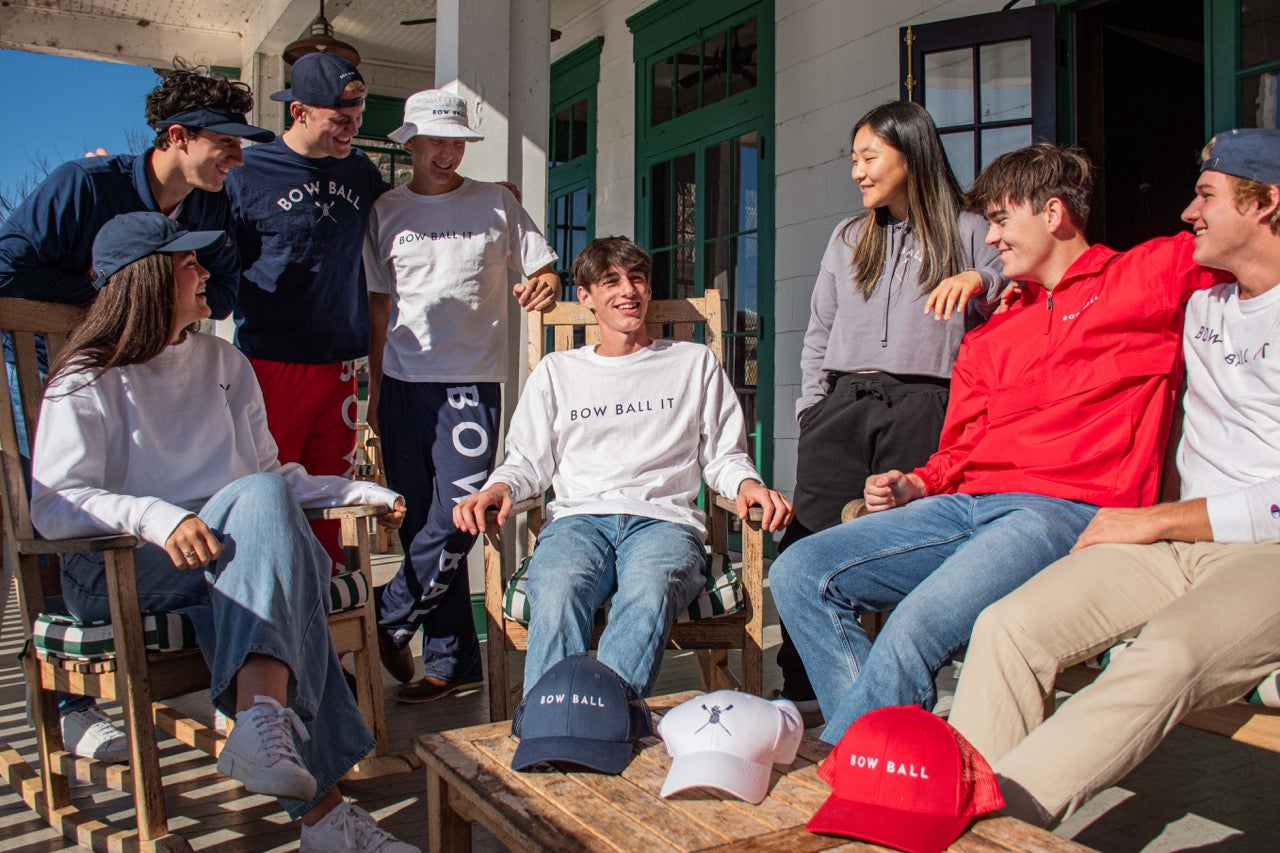 Friends laughing on balcony of boathouse 